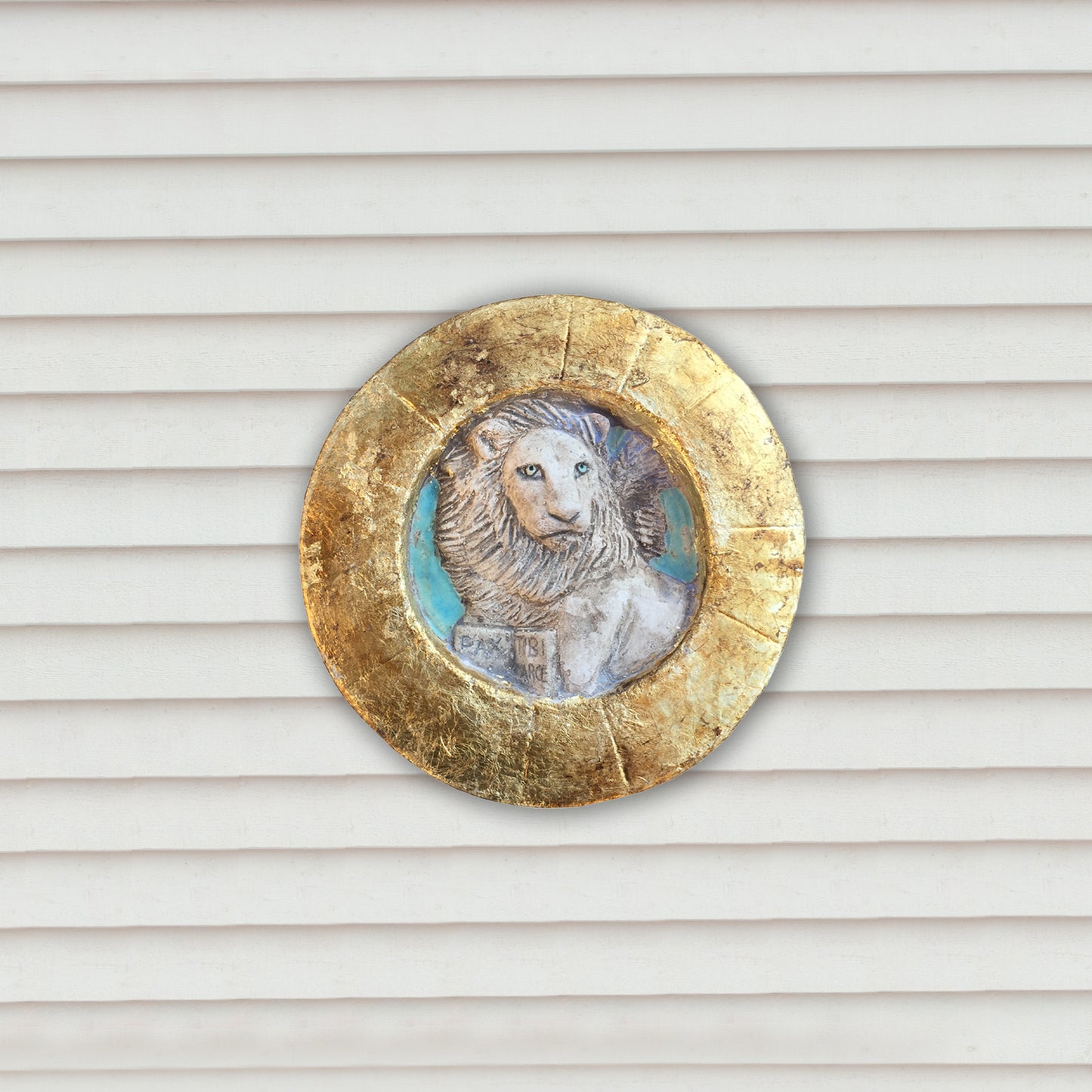 Piccolo Leone di San Marco entro tondo, con cornice dorata.